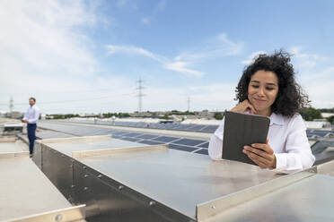 Geschäftsfrau mit Tablet-PC im Solarkraftwerk - JOSEF14170