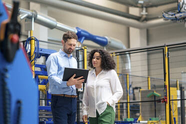 Businessman using tablet PC with colleague at industry - JOSEF14171