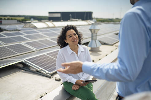 Businesswoman discussing with businessman at rooftop - JOSEF14421