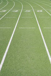 Numbers on empty running track at sports field - IFRF01769