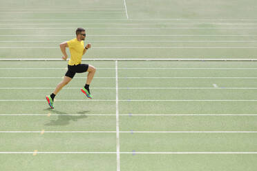 Sportsman doing running practice on sports track - IFRF01833