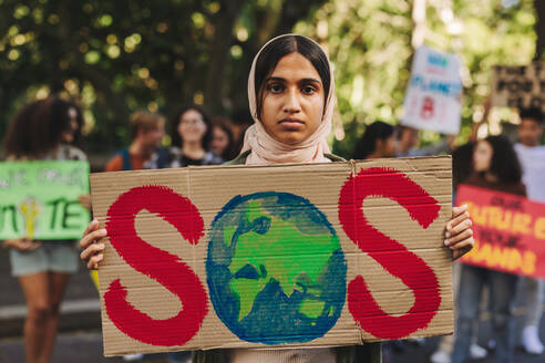 Muslim girl looking at the camera while holding a 