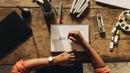 Designer drawing the word 