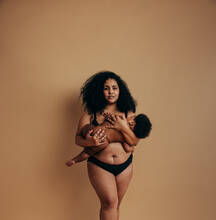Young women embracing their natural bodies in a studio. Two happy