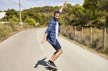 Mann genießt das Skateboardfahren an einem sonnigen Tag - VEGF06047