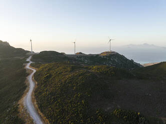 Greece, Aegean, Kos, Wind farm turbines at dawn - CVF02186