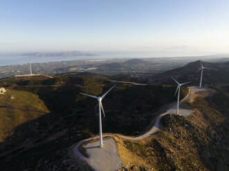 Greece, Aegean, Kos, Wind farm turbines at dawn - CVF02190