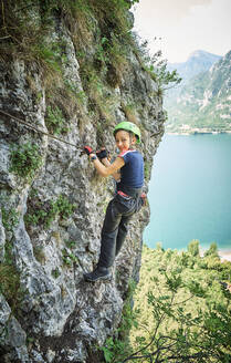 Smiling girl climbing mountain near Lake Idro - DIKF00742