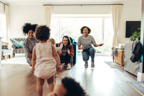 Single mom group playing with children indoors. Mothers and their children together in club. - JLPSF10399