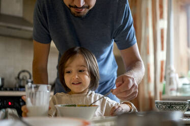 Father feeding cute son at home - ANAF00204