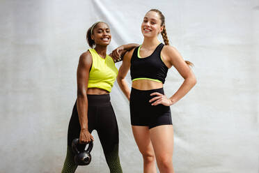 Woman wearing sports bra exercising with a kettle bell Stock Photo