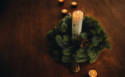 Advent wreath with burning candles on table. Christmas holiday decorations. - JLPSF11149