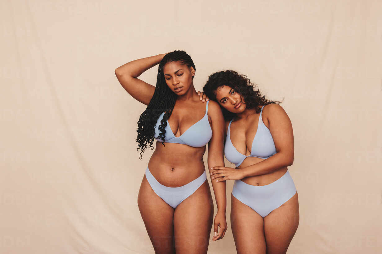 https://us.images.westend61.de/0001735371pw/two-body-positive-young-women-wearing-blue-underwear-in-a-studio-two-confident-young-women-embracing-their-natural-bodies-and-curves-young-women-standing-together-against-a-studio-background-JLPSF11194.jpg