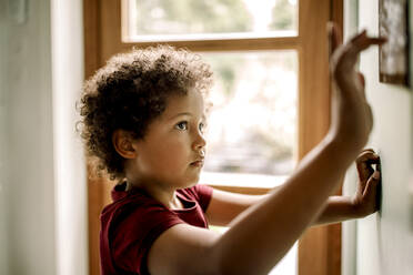 Curious boy using home automation on wall - MASF31994