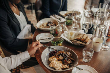 Young businessman having food with colleagues in hotel - MASF32181