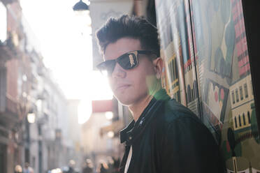 Young man wearing sunglasses on sunny day - EGAF02579