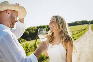Glückliche Frau und Mann genießen Wein in einer Weinkellerei - MDOF00018