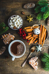 Von oben Tasse mit heißer Schokolade und Mini Marshmallows mit Gewürzen auf dem Hintergrund mit Weihnachtsdekorationen - ADSF39661