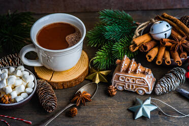 From above mug with hot chocolate and mini marshmallows with spices on background with christmas decorations - ADSF39663