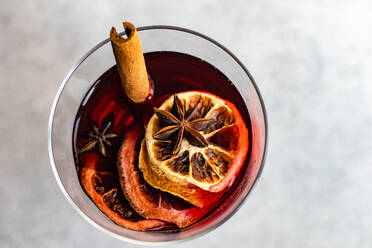 Overhead view of winter mulled wine with spices on concrete background - ADSF39666