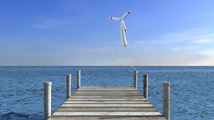 Ballon in Form einer Windturbine an einem Holzsteg befestigt - AHUF00697