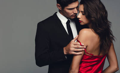 Stylish couple in a sensual moment. Romantic man and woman on grey background. - JLPSF11422