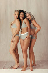 Three girls with different bodies posing in underwear in front of