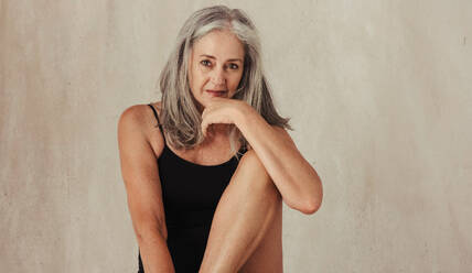 Mature woman embracing her natural and aging body. Confident woman