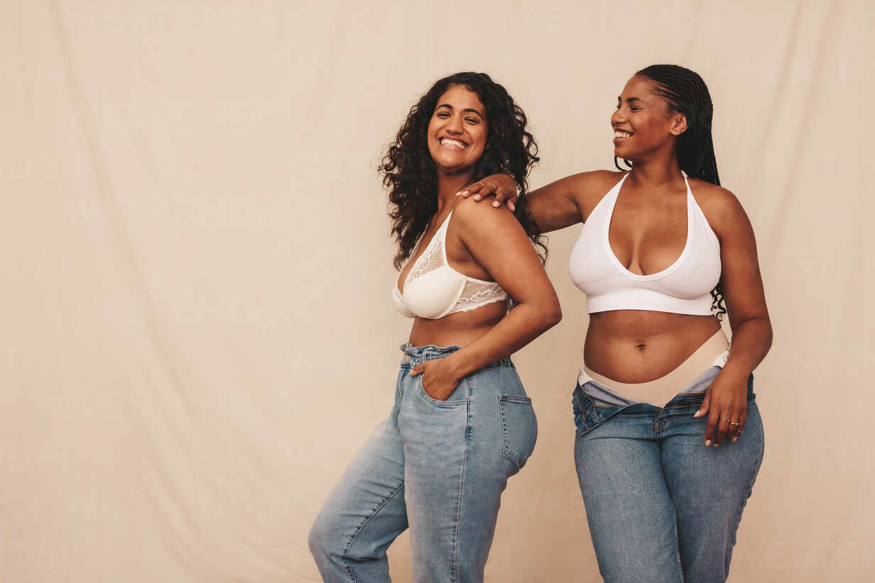 Two Young Attractive Women Smiling. Two Lovely Woman In Jeans And Bra by  Stocksy Contributor Screen Moment - Stocksy