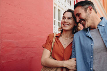 Couple walking on a sidewalk holding hands. Mature man and woman walking on city street. - JLPSF12473