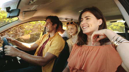 Family driving in a car on countryside road trip. Family with two children driving in a car. - JLPSF12487