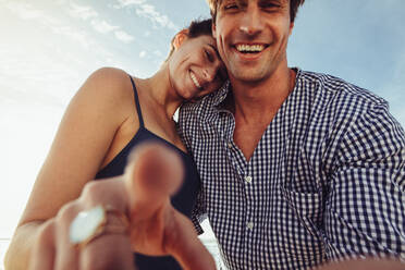 Woman touching screen from cellphone perspective. Couple taking selfie from mobile device point of view - JLPSF12530