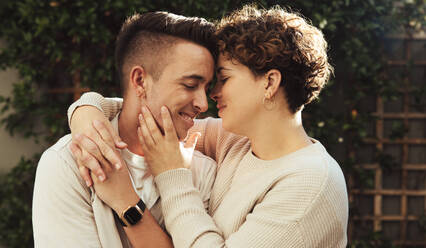 Schönes queeres Paar, das einen intimen Moment teilt. Romantisches junges Paar, das sich umarmt, während es zusammen im Freien steht. Junges LGBTQ+ Paar, das Zeit miteinander verbringt. - JLPSF12581
