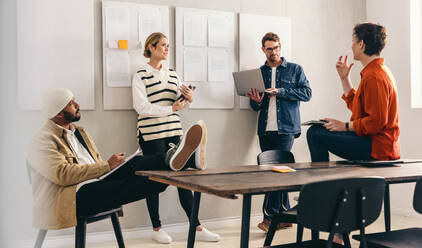 Creative business team having a group discussion during a meeting in a boardroom. Diverse businesspeople sharing ideas while working together in a modern workplace. - JLPSF12791