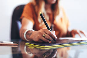 Close up of the hand of an illustrator making a design using a drawing pad. Cropped shot of a female creative artist working on a digital drawing pad. - JLPSF13699