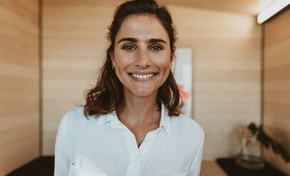 Close-up of a businesswoman smiling in office. Happy female executive looking at camera with a smiling. - JLPSF13825