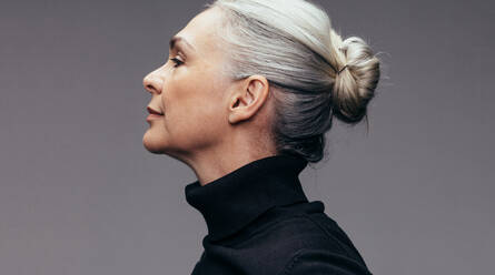 Side view of senior woman on gray background. Profile view of mature woman in black casuals. - JLPSF14518