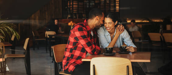 Romantic couple sitting together inside a cafe. Couple in love on a date - JLPSF14622