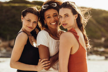 Multiethnic women friends standing together outdoors. Portrait of women on a holiday. - JLPSF14684