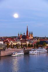 Germany, Bavaria, Wurzburg, Moon glowing over river Main with Wurzburg Cathedral and Marienkapelle in background - NDF01542