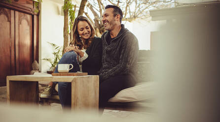 Smiling man and woman sitting at coffee shop. Couple sitting at a cafe during a first date. - JLPSF15009