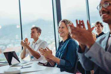 Group of male and female business professionals clapping hands in conference. Audience applauding after successful seminar. - JLPSF15394