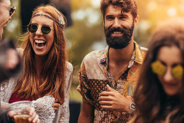 Portrait of happy young hippie friends at music festival. Group of men and women at music festival. - JLPSF15714