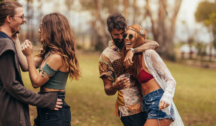 Group of men and women at music festival. Friends having a great time at music festival in a park. - JLPSF15718