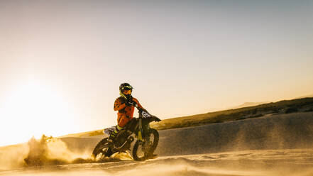 Rider riding dirt bike in the sand. Motocross race practice in desert. - JLPSF15871