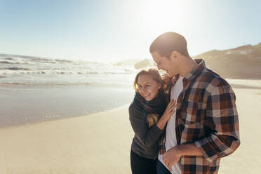 Portrait of happy young woman with her boyfriend on the sea shore. Loving couple on the beach enjoying holidays. - JLPSF15967