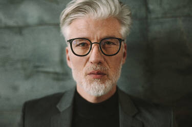 Close up portrait of senior businessman with white hair wearing glasses. Mature man with beard looking at camera. - JLPSF16705