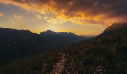 Amazing view of sunset over the mountain with dark cloudscape. Sunset in Jonkershoek nature reserve. - JLPSF16967