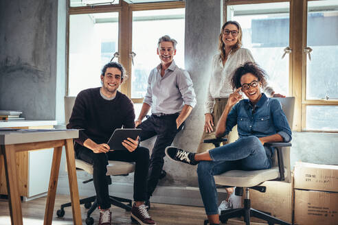 Portrait of successful group of people working at online web store. Men and women at ecommerce business office. - JLPSF17604