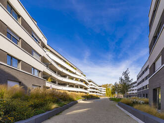 Germany, Baden-Wurttemberg, Ostfildern, Road stretching between modern apartment buildings - WDF07101